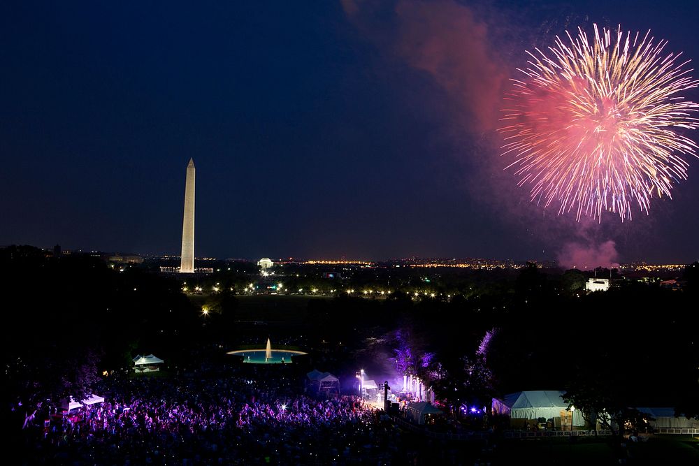 With Brad Paisley onstage, a crowd watches from the South Lawn of the White House as fireworks erupt over the National Mall…
