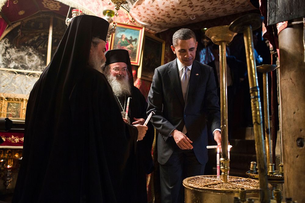 President Barack Obama lights candles as he tours the crypt containing the birthplace of Jesus during his visit to the…
