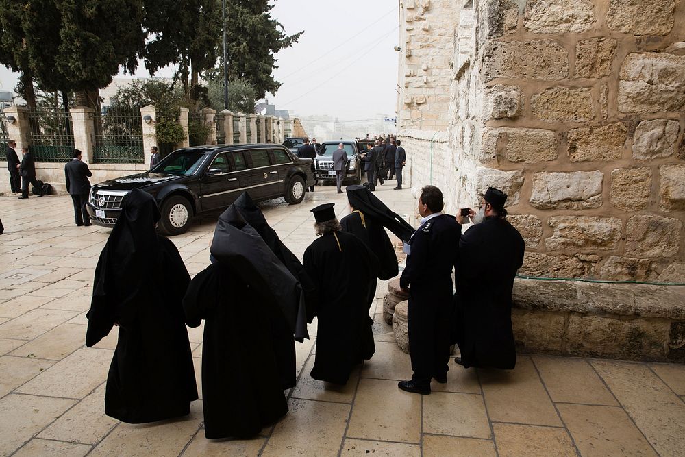 Clergy watch as the President's motorcade prepares to depart the Church of the Nativity in Bethlehem, the West Bank, March…