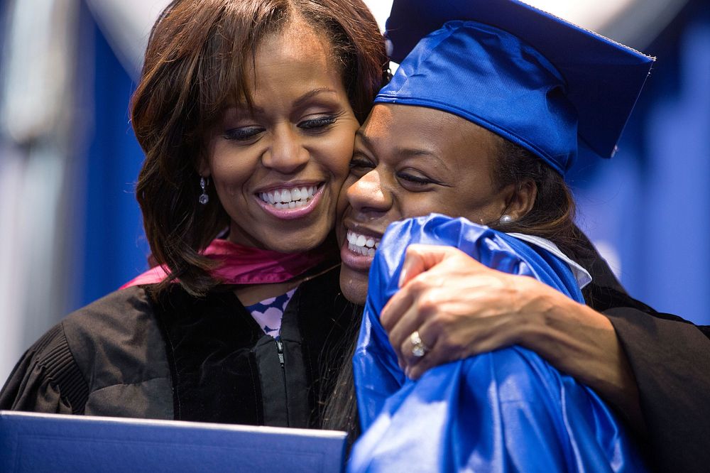 First Lady Michelle Obama hands a diploma to a graduating senior during the Martin Luther King, Jr. Academic Magnet High…