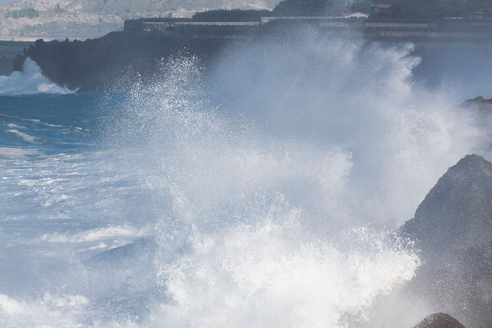 Sea waves crashing into rocks. Free public domain CC0 photo.