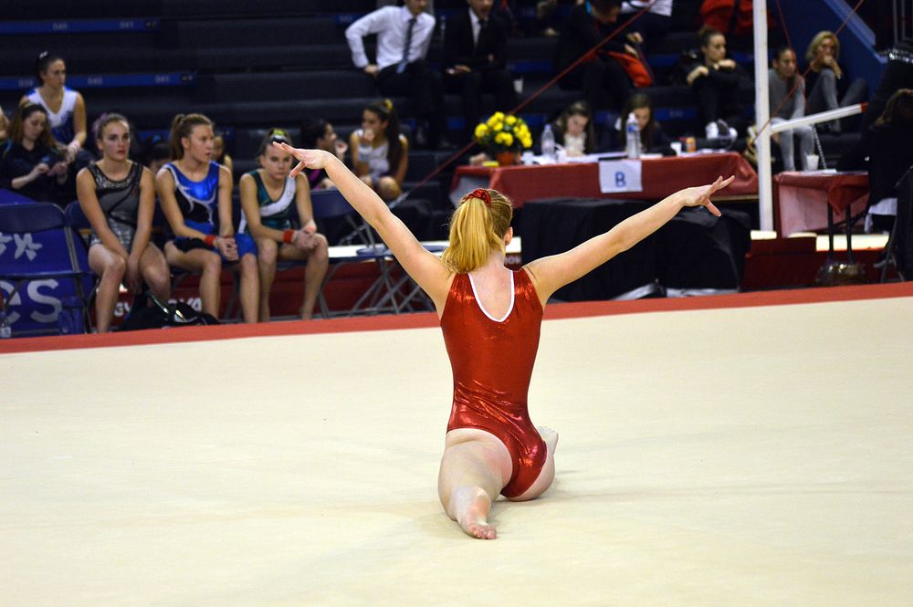Gymnast doing split on mat in competition, location unknown, 7 February 2016. View public domain image source here