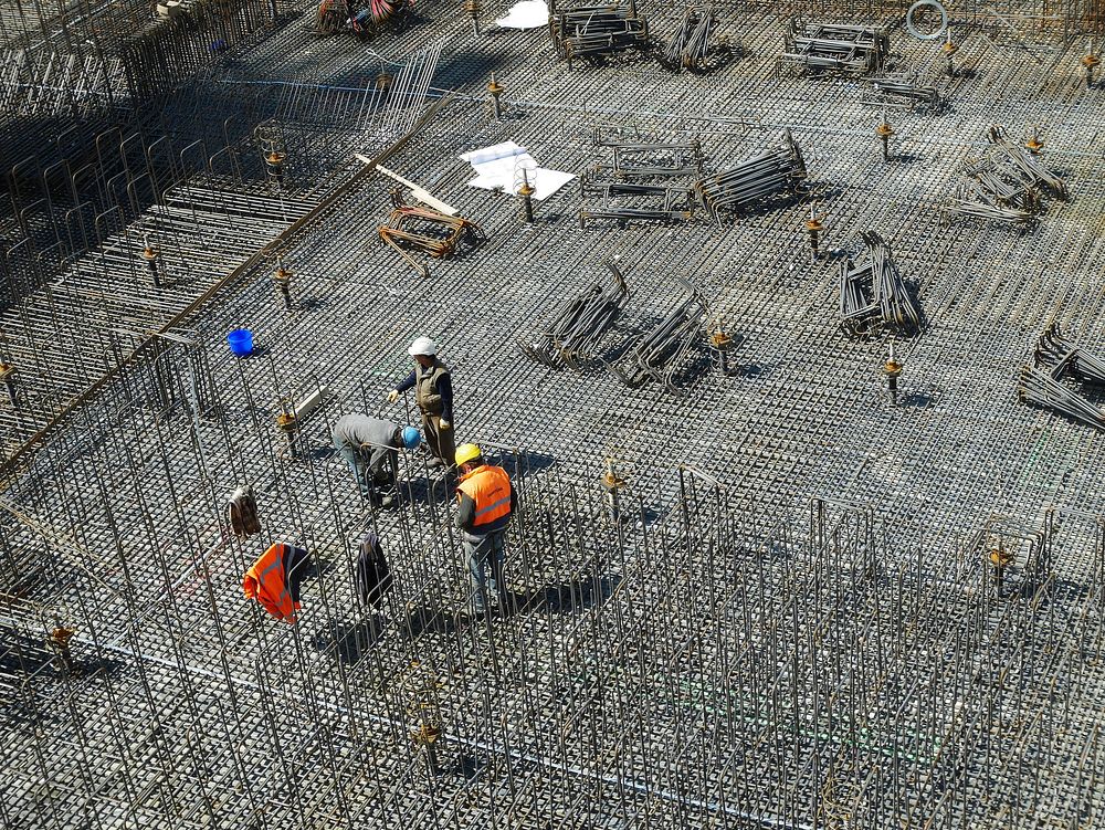 Builders at construction site. Free public domain CC0 photo.