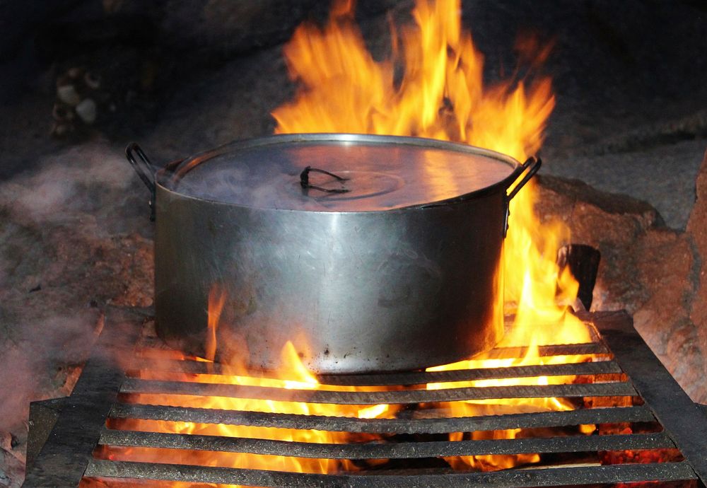 Boiling pot on fire. Free public domain CC0 photo.