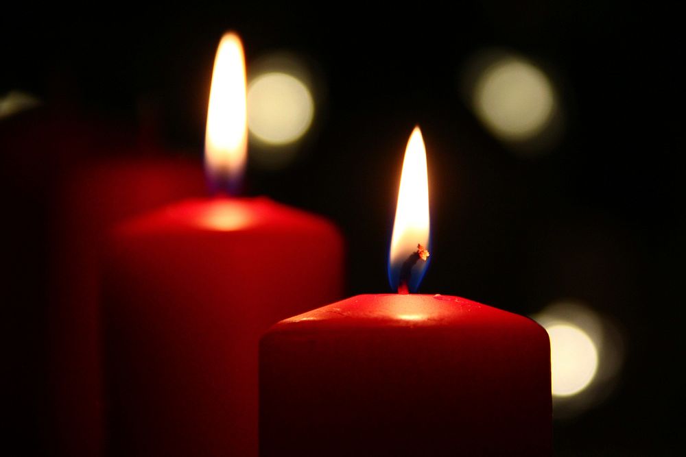 Burning red candles in the dark. Free public domain CC0 image.