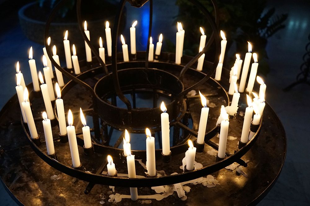 Candles light in church. Free public domain CC0 photo.