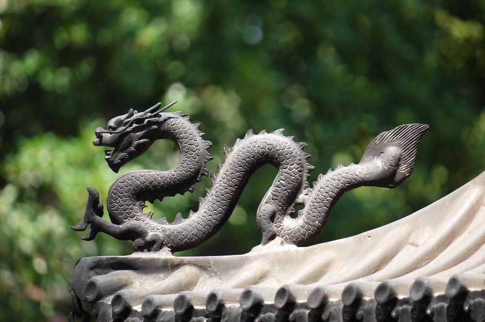 Dragon on monument in China background. Free public domain CC0 image.