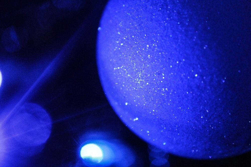 Close up christmas light, blue glitter. Free public domain CC0 photo.