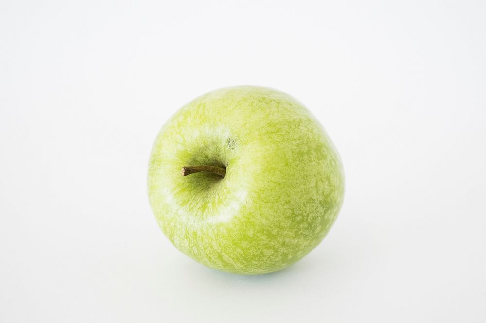 Closeup on green apple on white background. Free public domain CC0 photo.
