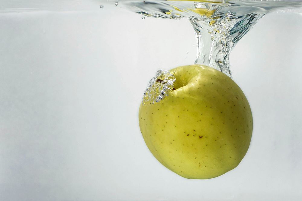 Green apple under water. Free public domain CC0 photo.