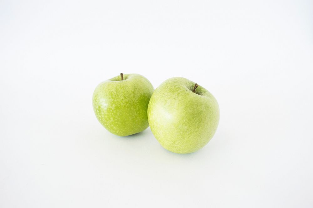 Closeup on green apples on white background. Free public domain CC0 photo.