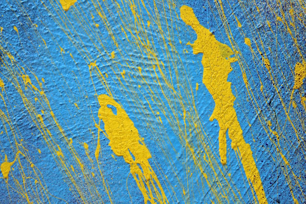 Yellow color splash on blue wall. Free public domain CC0 photo.