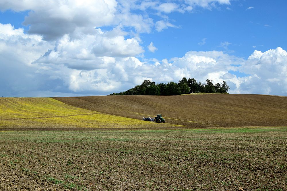Tractor on agricultural land. Free public domain CC0 photo.