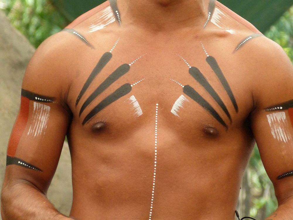 Tribal patterns on man's chest. Free public domain CC0 photo.