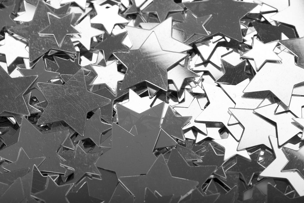 Pile of silver star confetti decoration. Free public domain CC0 image.