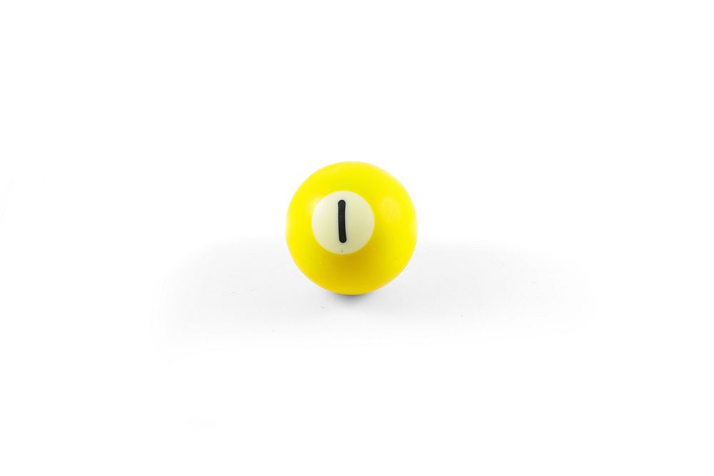 Closeup on yellow pool ball on white background. Free public domain CC0 image.