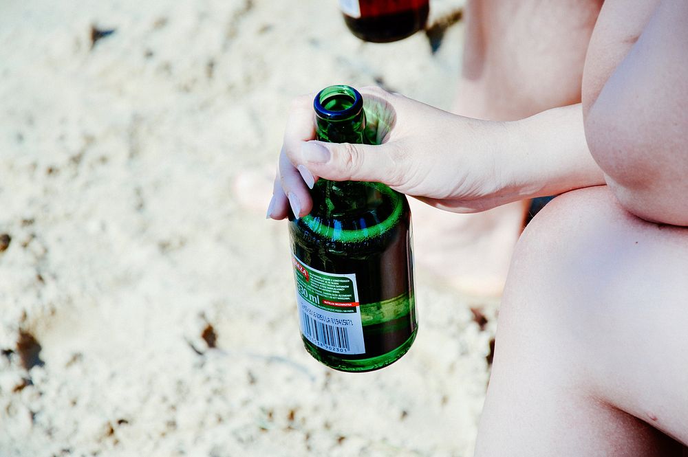 Beer bottle at the beach. Free public domain CC0 photo.