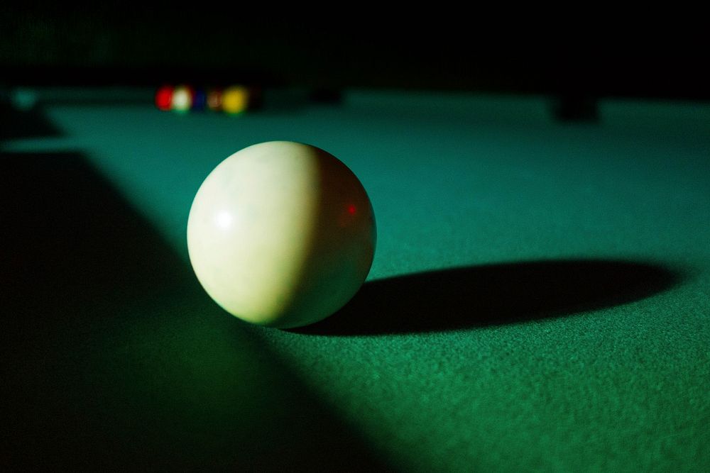 Closeup on cue ball on pool table. Free public domain CC0 image.