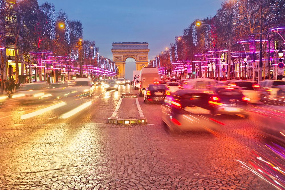 Night view of Arc de Triomphe with vehicle light trails effect