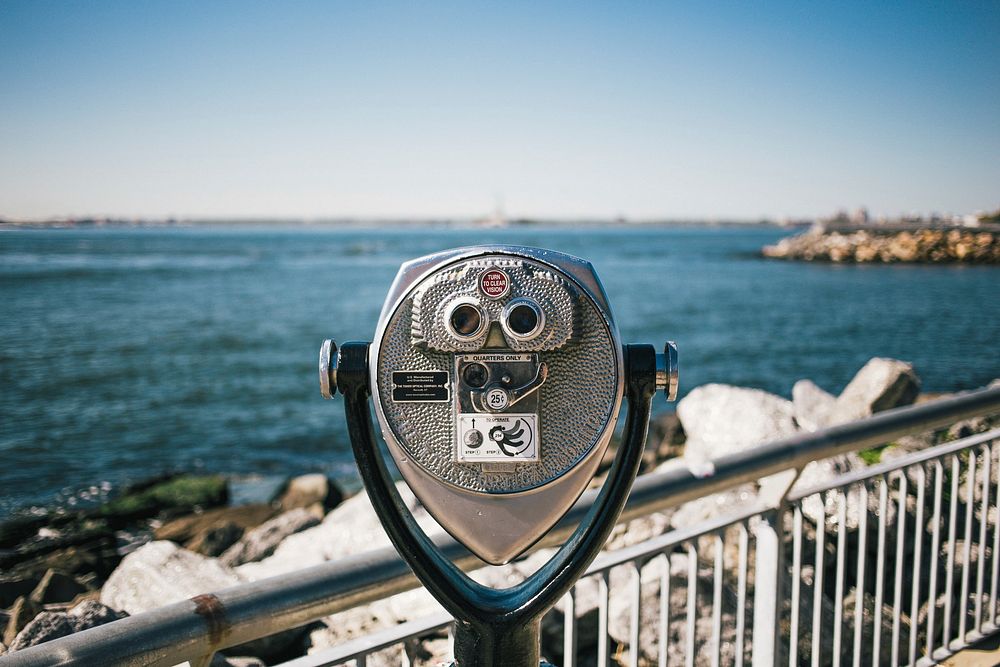 Free coin operated binoculars at the beach with horizon in the background image, public domain travel CC0 photo.