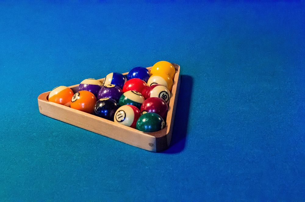 Closeup on pool ball inside rack on table. Free public domain CC0 image.