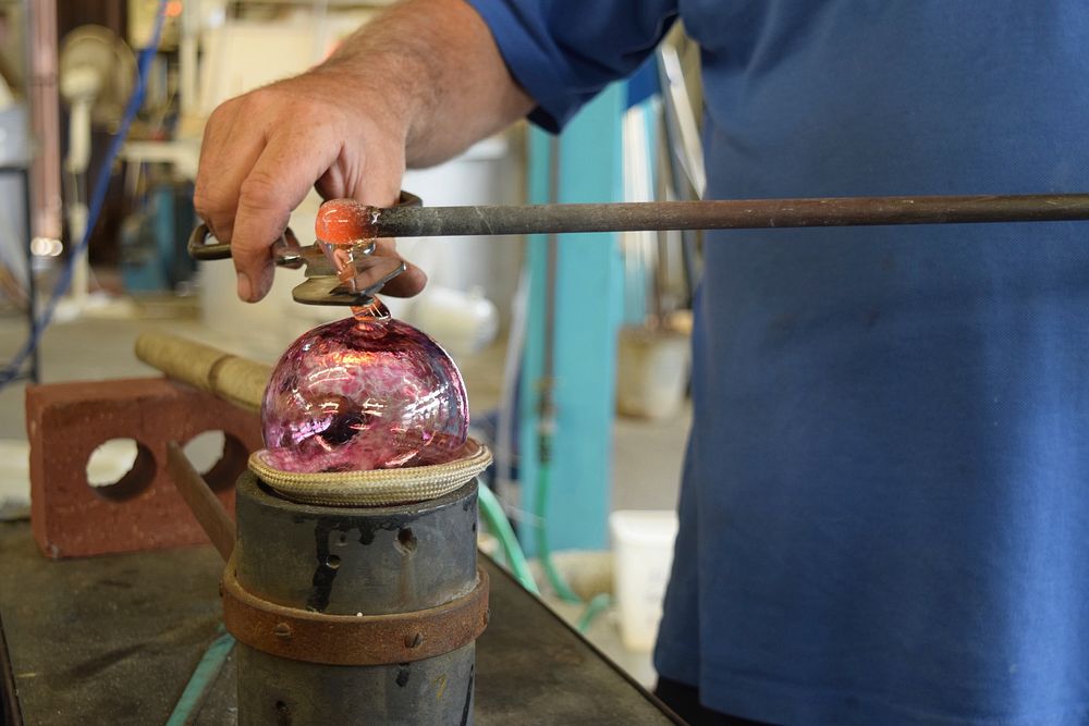 Glass blower in hot shop. Free public domain CC0 photo.