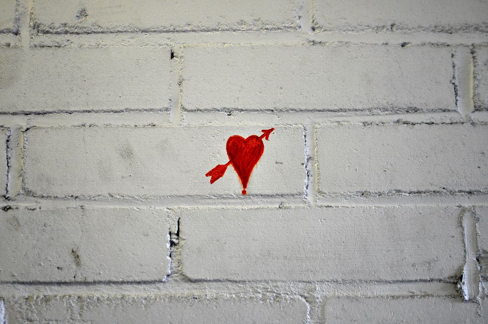 Heart on white brick wall. Free public domain CC0 image.