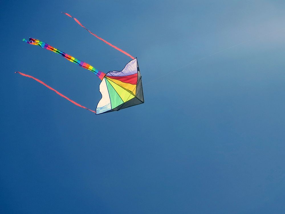 Kite in blue sky. Free public domain CC0 image.
