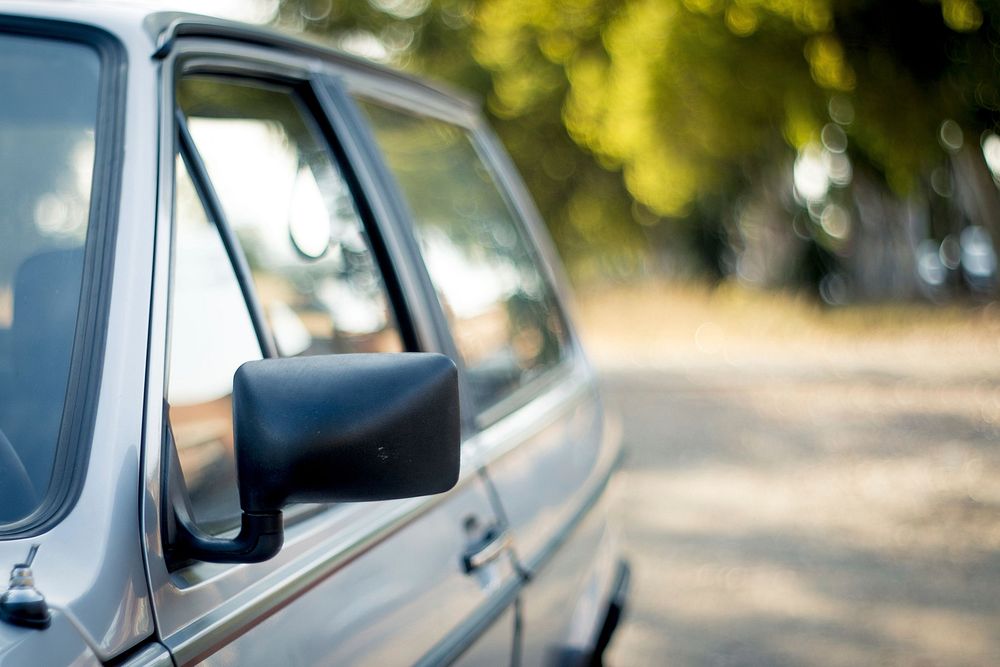 Blur view of side-view mirror of car. Free public domain CC0 photo.