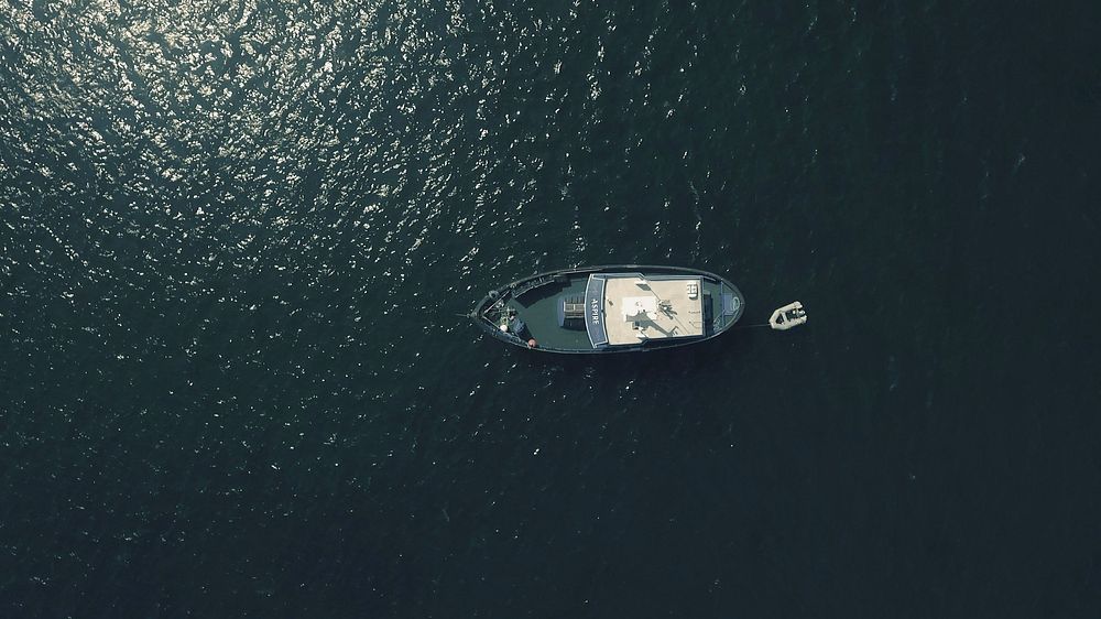 Aerial view of boat in ocean. Free public domain CC0 photo.