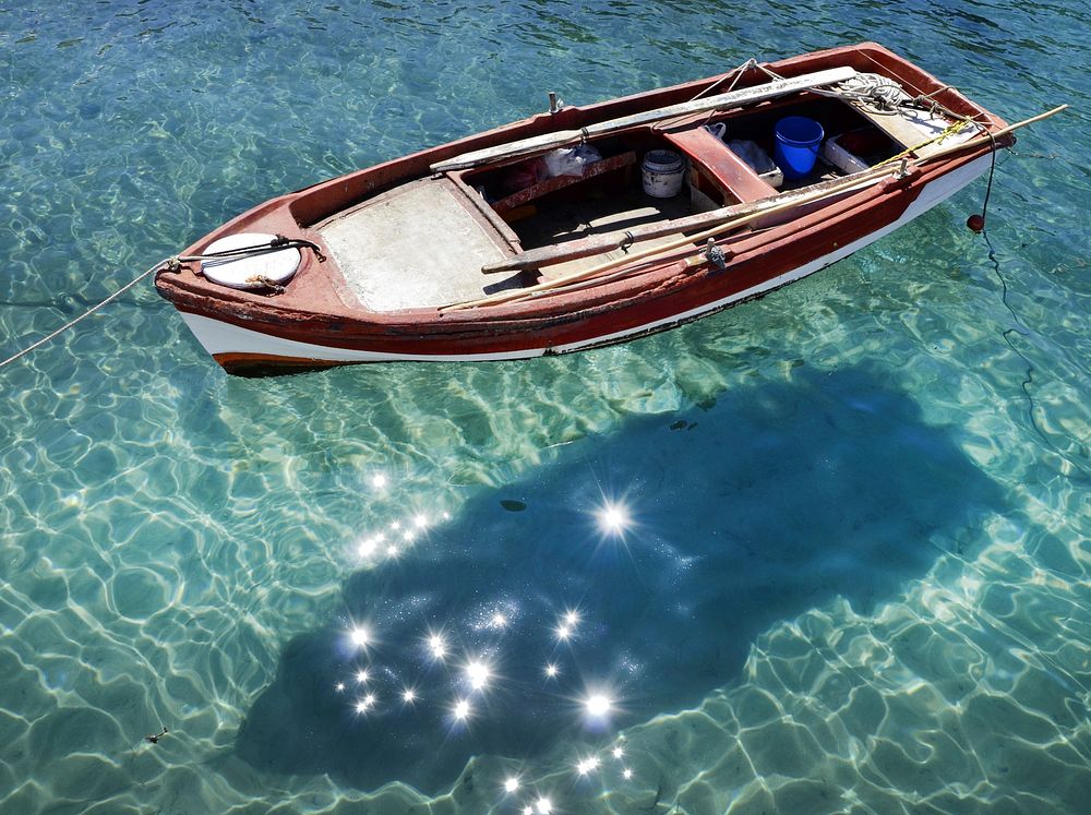 Fishing boat on clear water. Free public domain CC0 photo.