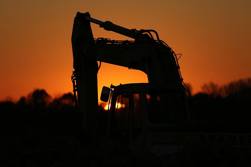 Excavator silhouette. Free public domain CC0 photo.
