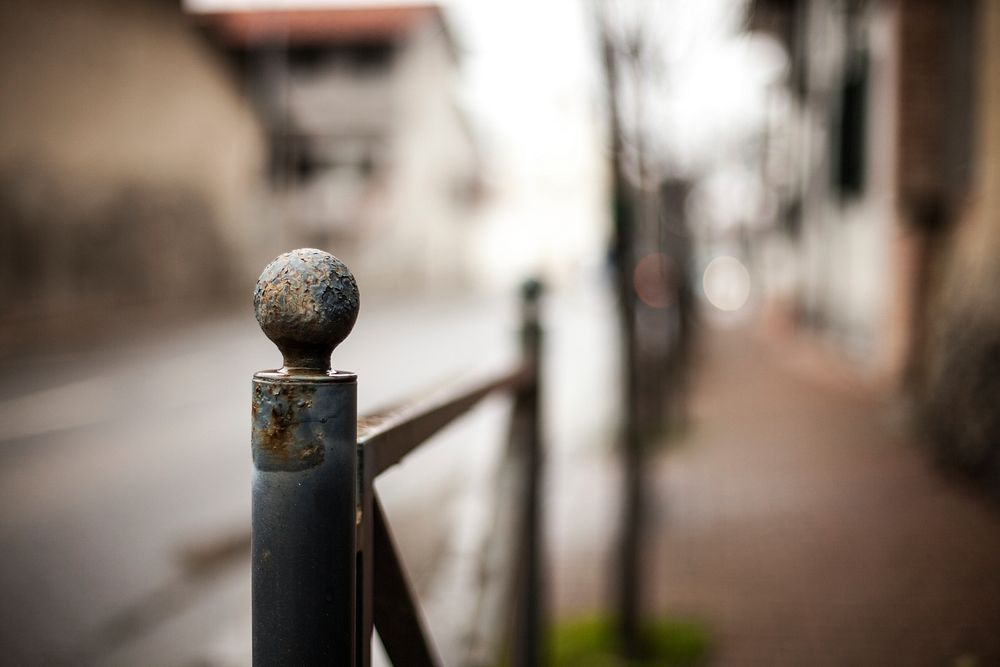 Metal fence pole on a street. Free public domain CC0 photo