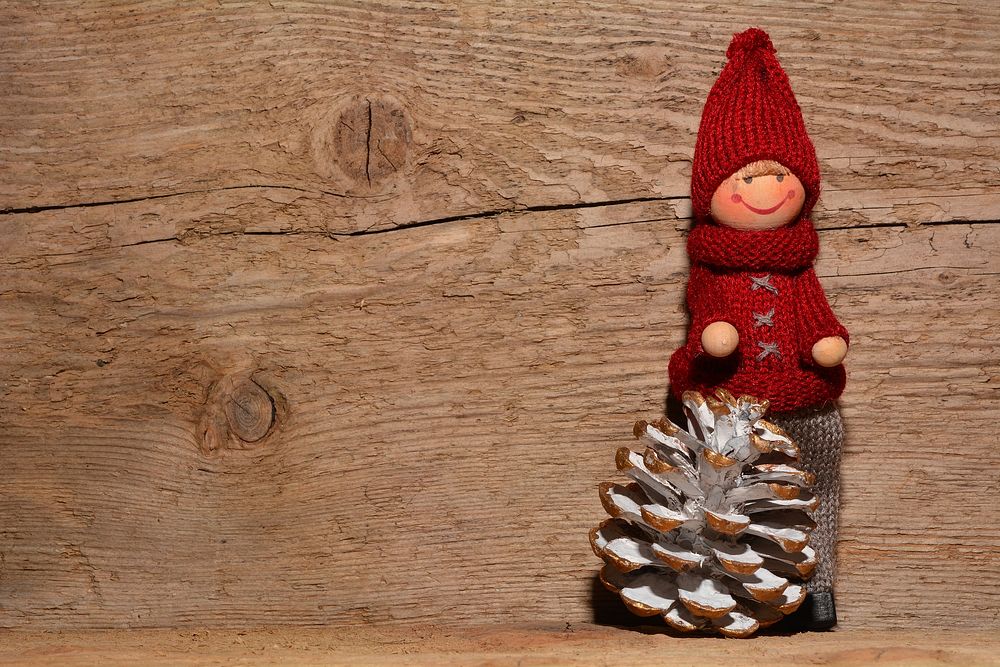 Christmas doll on wood background. Free public domain CC0 photo.