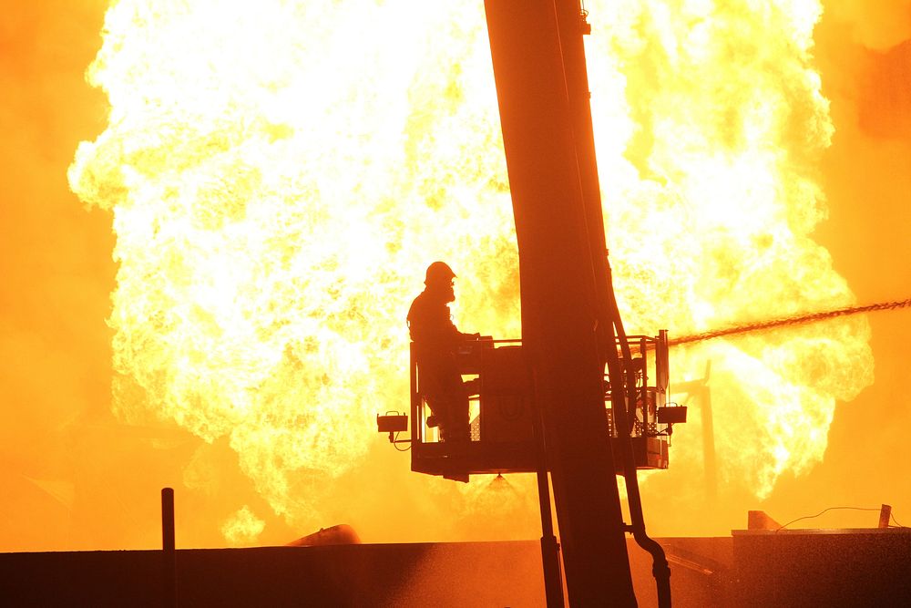 Fireman putting out fire. Free public domain CC0 photo.