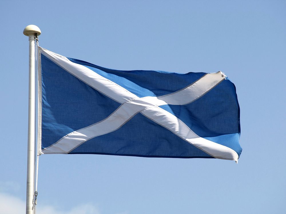 Scotland flag against blue sky. Free public domain CC0 photo