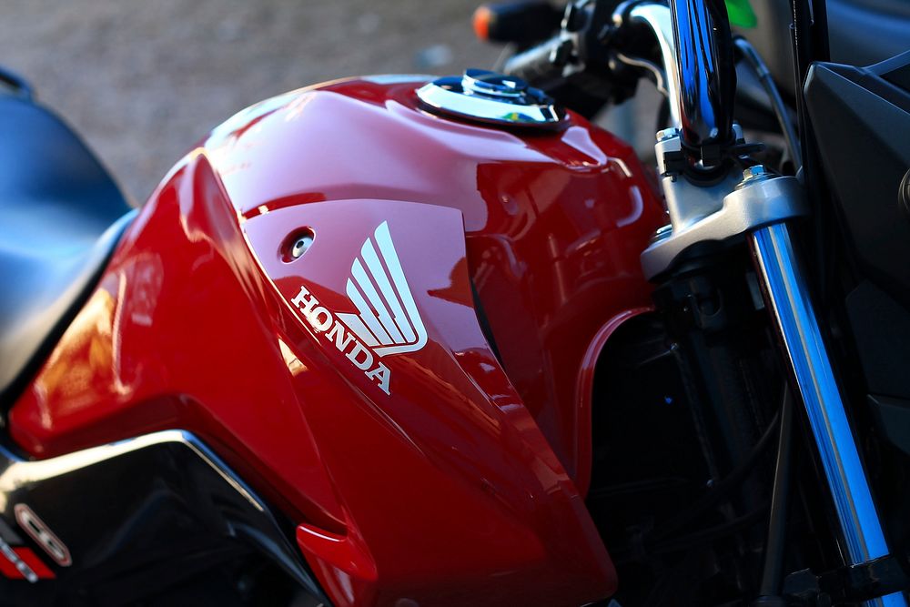 Red honda motorbike closeup, location unknown, date unknown.