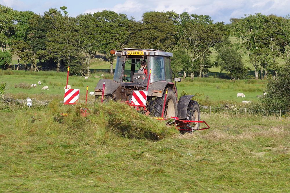 Hay harvesting farm tractor. Free public domain CC0 photo.