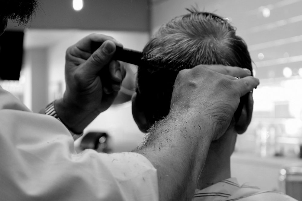 Man getting haircut at barber. Free public domain CC0 photo.