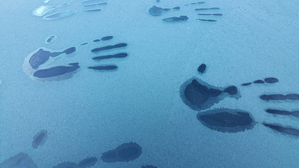 Hand prints on frosty car window. Free public domain CC0 image.