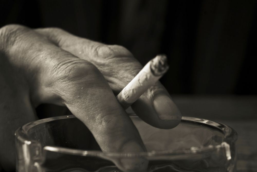 Old man smoking & drinking. Free public domain CC0 photo.