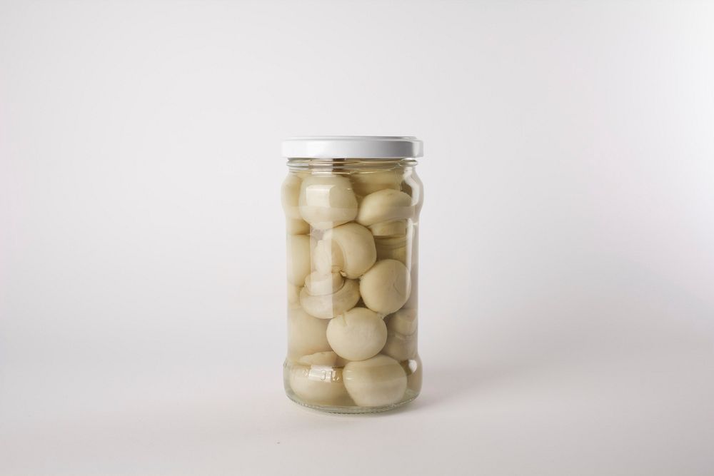 Canned white mushrooms in a jar. Free public domain CC0 photo.