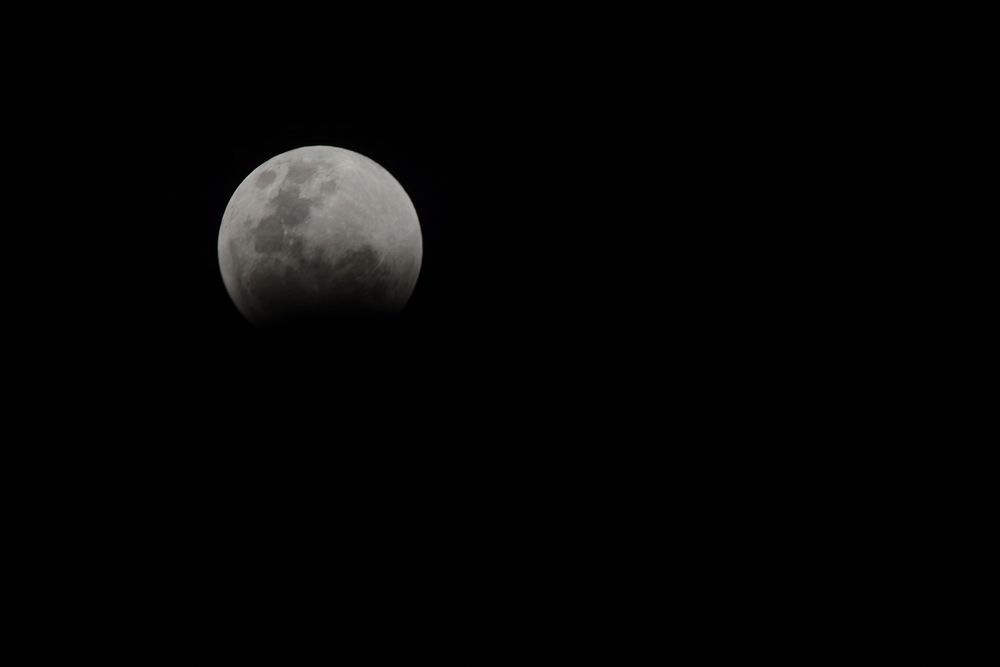 Waning moon in dark sky. Free public domain CC0 photo.