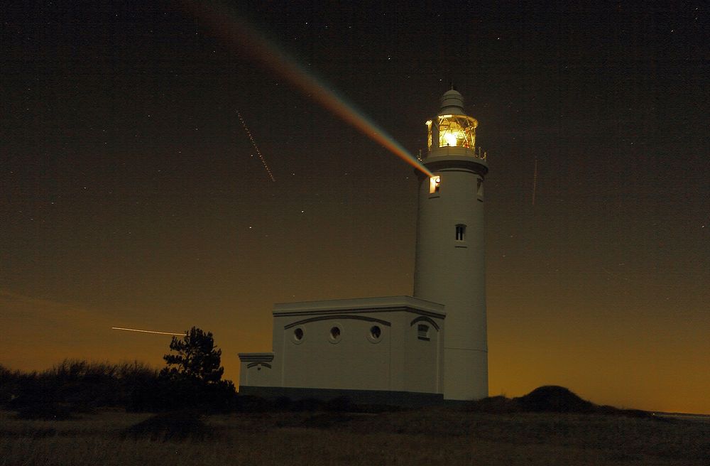 Lighthouse at night. Free public domain CC0 image.