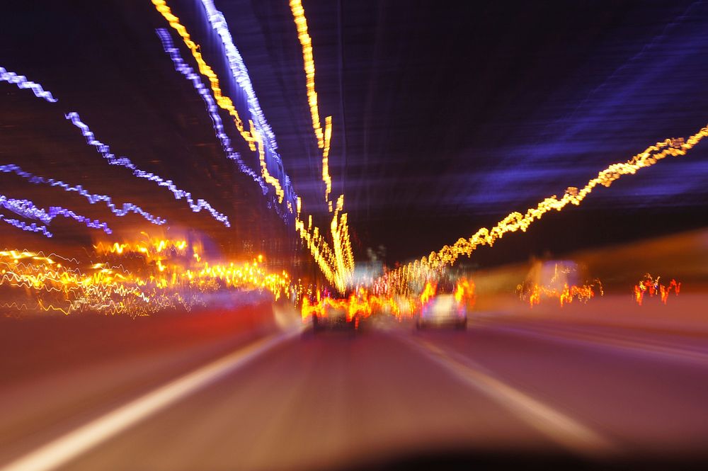 Car speeding on the road at night. 