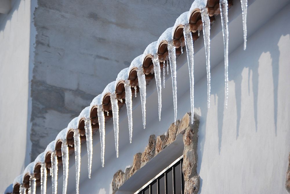 Closeup on icicles from a roof. Free public domain CC0 photo.