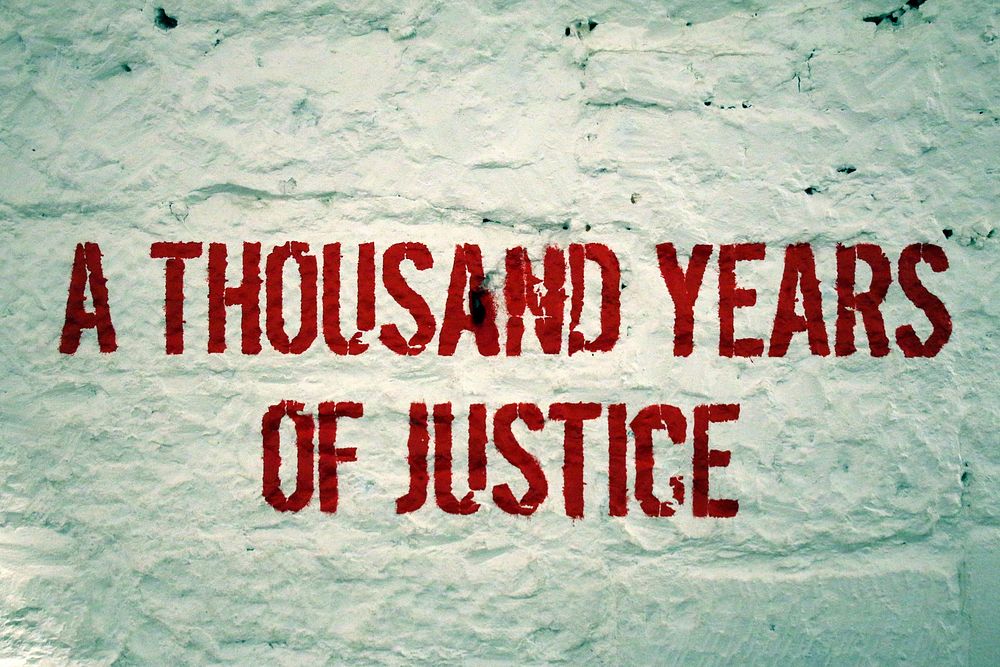 A thousand years of justice text on wall. Free public domain CC0 photo.