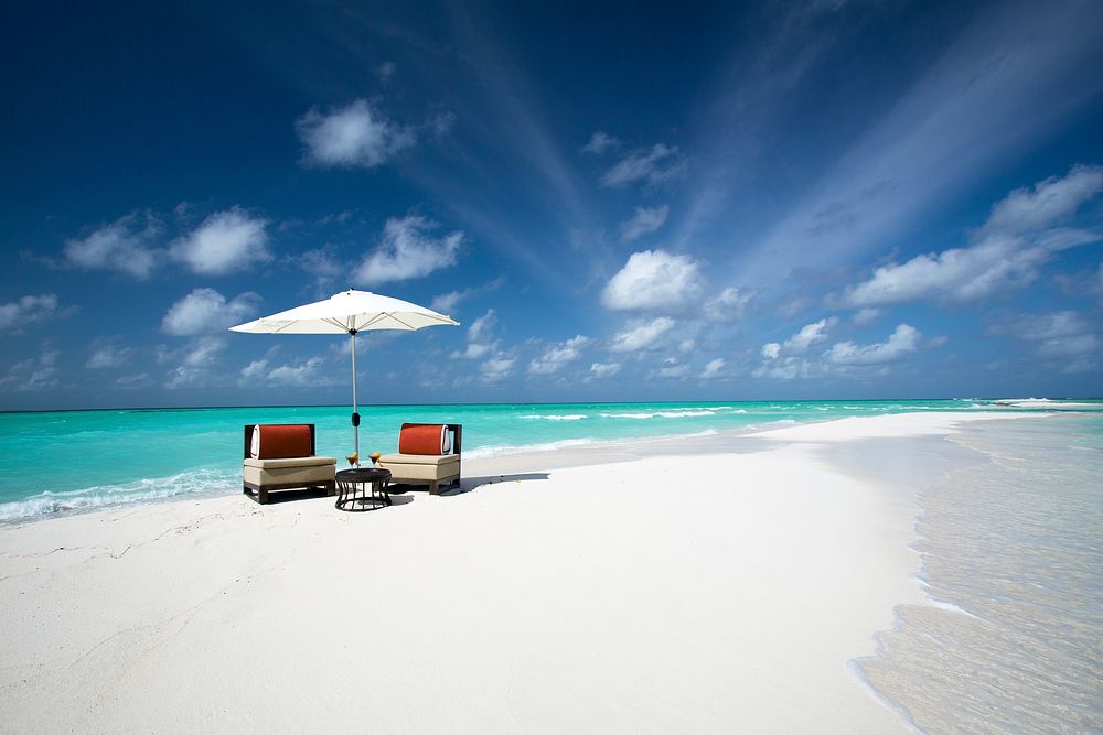 Sandbank beach with empty chairs. Free public domain CC0 image.