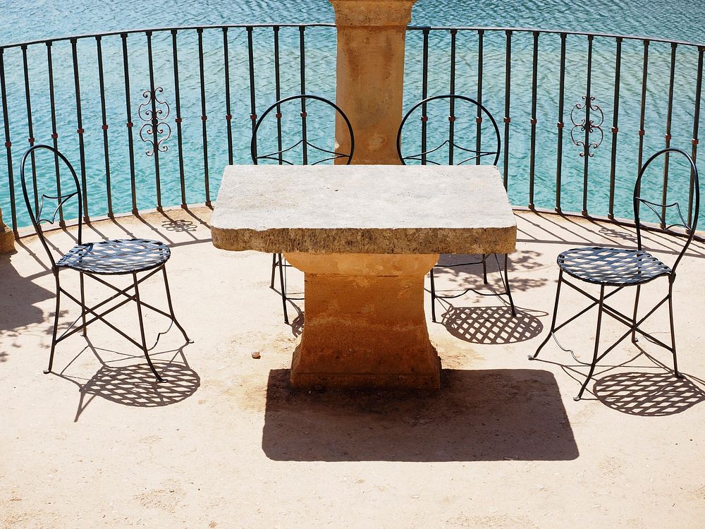 Table and chair on the balcony. Free public domain CC0 image.