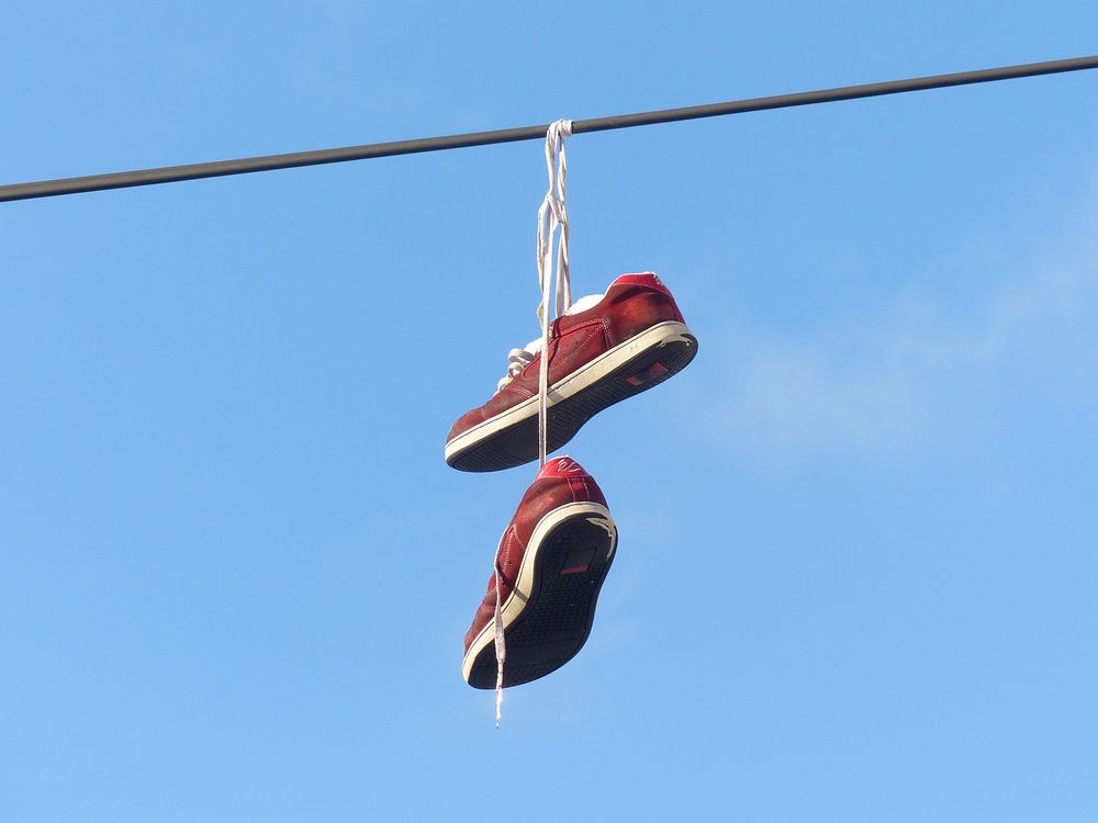 Sneaker shoes hanging in the air. Free public domain CC0 image